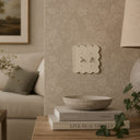 Scallop 2G Toggle Wall Plate in Warm Ivory in a living room
