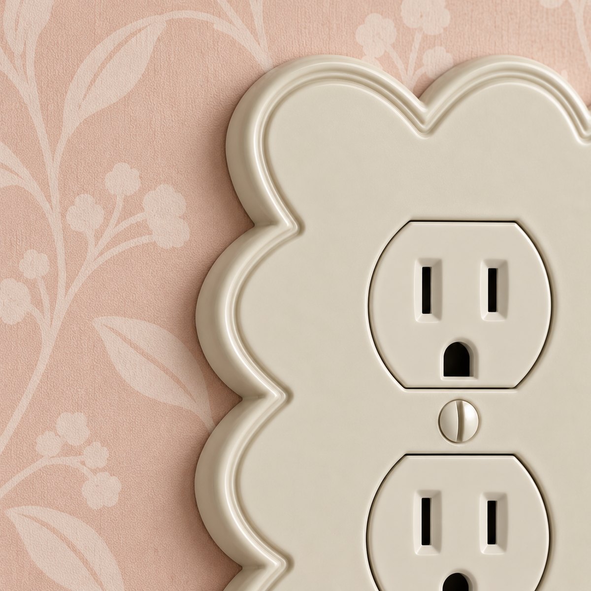 Close-up of a Scallop duplex wall plate in Warm Ivory