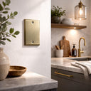 Signature 1G Blank wall plate in Aged Gold on a wall in a styled room