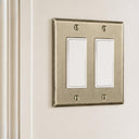 Signature 2-gang rocker switch plate in Aged Gold installed on a wall