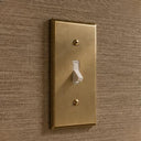 Signature 2-gang toggle switch plate in Aged Gold, room setting