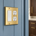 Signature 2G Rocker Duplex combo wall plate in Brushed Brass on a blue beadboard wall